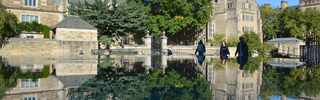 the sky and Yale’s buildings reflected in a pool of water